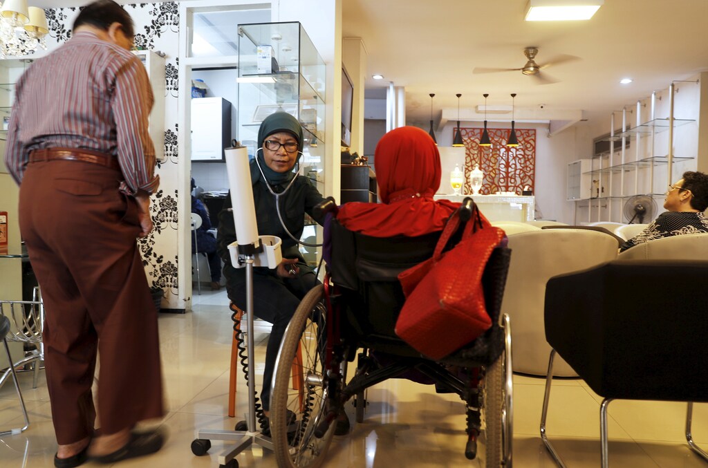 A paramedic checks the blood pressure of patients at SS Diabetes Care clinic in Jakarta, Indonesia, April 22, 2016.