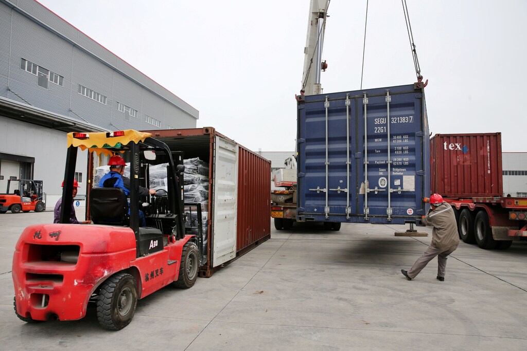 Men work on unloading the rubber imported from Belt and Road Initiative (BRI) countries at a bonded logistics centre in Nantong, Jiangsu province, China, May 2019.