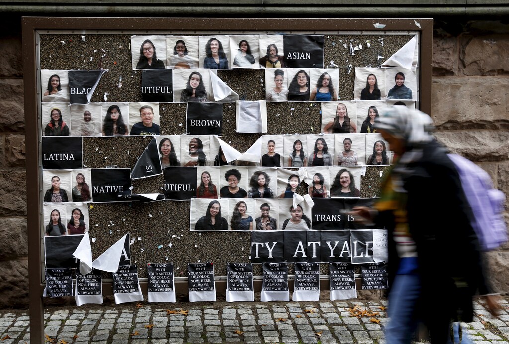A student walks by a college noticeboard on campus at Yale University in New Haven, Connecticut November 12, 2015. More than 1,000 students, professors and staff at Yale University gathered on Wednesday to discuss race and diversity at the elite Ivy League school, amid a wave of demonstrations at U.S. colleges over the treatment of minority students. REUTERS/Shannon Stapleton - GF20000057014