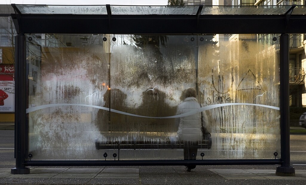 The heat impressions of people waiting for a bus are left in a cold morning frost on the glass of a transit shelter in Vancouver, British Columbia February 6, 2012. REUTERS/Andy Clark (CANADA - Tags: SOCIETY ENVIRONMENT) - RTR2XFBF