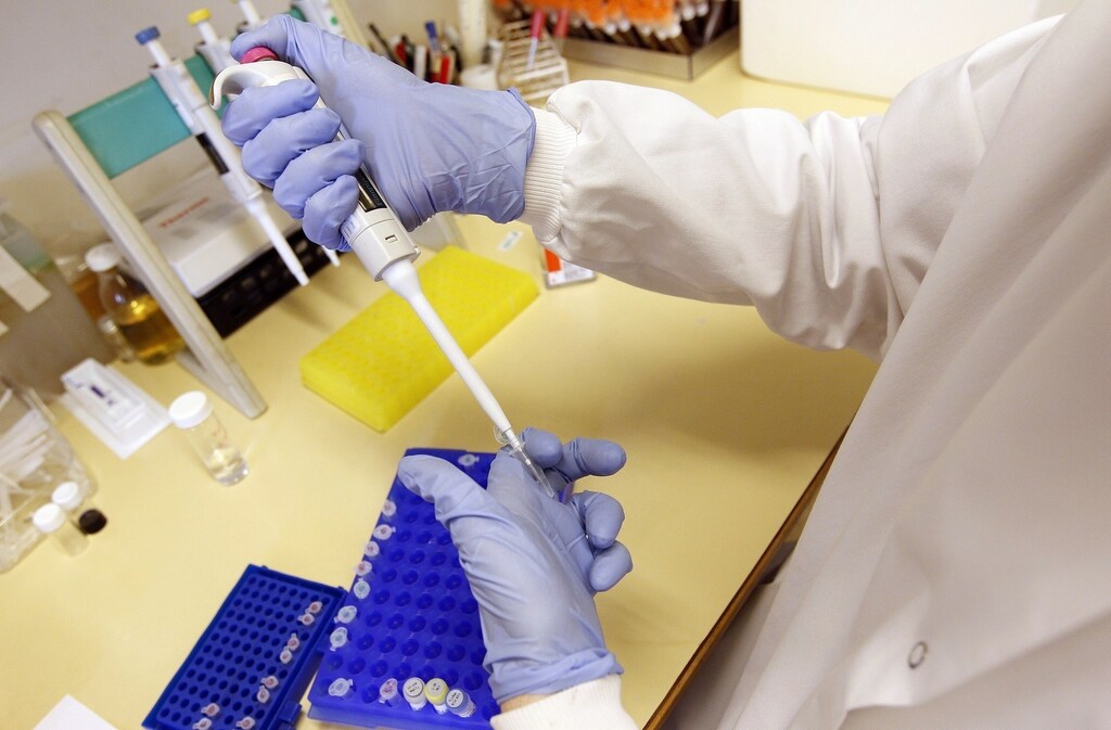 Christian LaVallee prepares solutions for polymerase chain reaction (PCR) tests at the Health Protection Agency in north London March 9, 2011. For decades scientists have managed to develop new medicines to stay at least one step ahead of the ever-mutating enemy, bacteria. Now, though, we may be running out of road