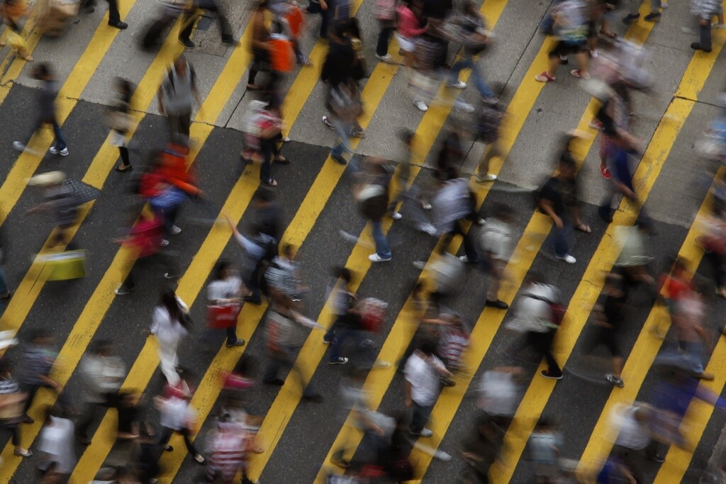ATTENTION EDITORS - IMAGE 1 OF 22 OF PICTURE PACKAGE '7 BILLION, 7 STORIES - OVERCROWDED IN HONG KONG. SEARCH 'MONG KOK' FOR ALL IMAGES - People cross a street in Mong Kok district in Hong Kong, October 4, 2011. Mong Kok has the highest population density in the world, with 130,000 in one square kilometre. The world's population will reach seven billion on 31 October 2011, according to projections by the United Nations, which says this global milestone presents both an opportunity and a challenge for the planet. While more people are living longer and healthier lives, says the U.N., gaps between rich and poor are widening and more people than ever are vulnerable to food insecurity and water shortages. Picture taken October 4, 2011. REUTERS/Bobby Yip (CHINA - Tags: SOCIETY) - RTR2SQJP