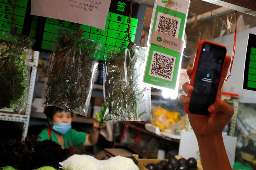A person scans the QR code of the digital payment services WeChat Pay at a fresh market in Beijing, China August 8, 2020. REUTERS/Thomas Peter - RC2H9I9YYSZD