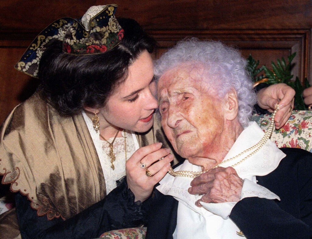 Jeanne Calment, officially listed as the world's oldest person celebrates her 121st birthday with a kiss from Catherine Sautecoeur (L) who presents her with a pearl necklace at the town hall in the southern French town of Arles, February 21. The "Doyenne of Humanity" recently hit the headlines with the release of a rap-funk record - PBEAHUMSYAB