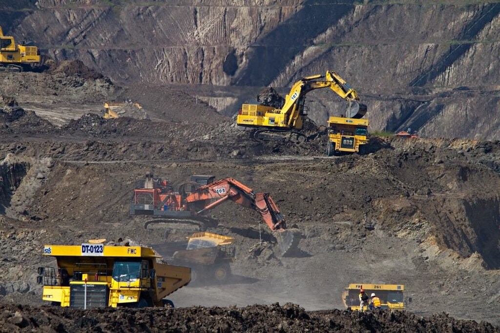 A coal mine, with 3 diggers working.