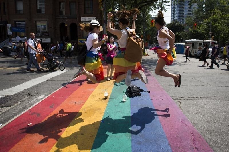 Revelers jump on a rainbow painted crosswalk in Church Street, Toronto's LGBT neighbourhood, before " WorldPride", a gay pride parade, in Toronto, June 29, 2014. Toronto is hosting WorldPride, a week-long event that celebrates the lesbian, gay, bisexual and transgender (LGBT) community.