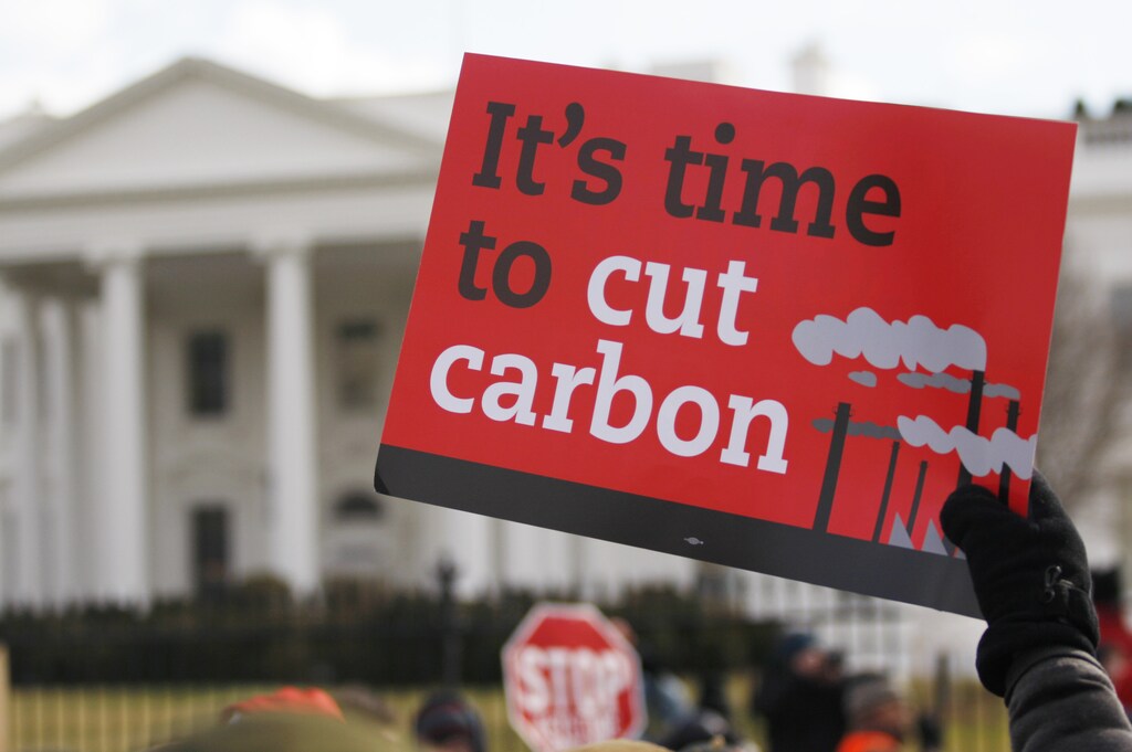 A demonstrator holds up a sign during a march past the White House to protest against the Keystone XL pipeline in Washington, February 17, 2013. The TransCanada Corp pipeline would link the oil sands of northern Alberta, the world's third largest crude resource, to refineries and ports in Texas. Environmentalists say approval of the pipeline will encourage more development in the oil sands, where extraction is carbon intensive, leading to greater greenhouse gas emissions. REUTERS/Richard Clement (UNITED STATES - Tags: ENVIRONMENT POLITICS CIVIL UNREST ENERGY) - RTR3DXGE