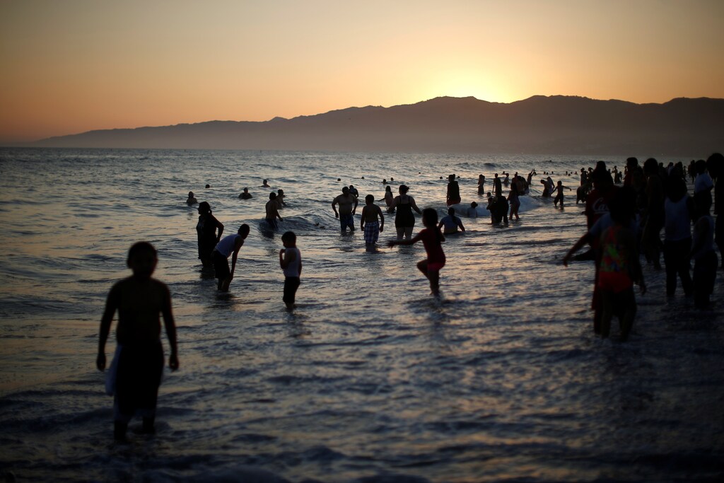 People cool off in the Pacific Ocean during a record-setting heat wave across the U.S. Southwest, on the summer solstice in Santa Monica, California, U.S. June 20, 2016.