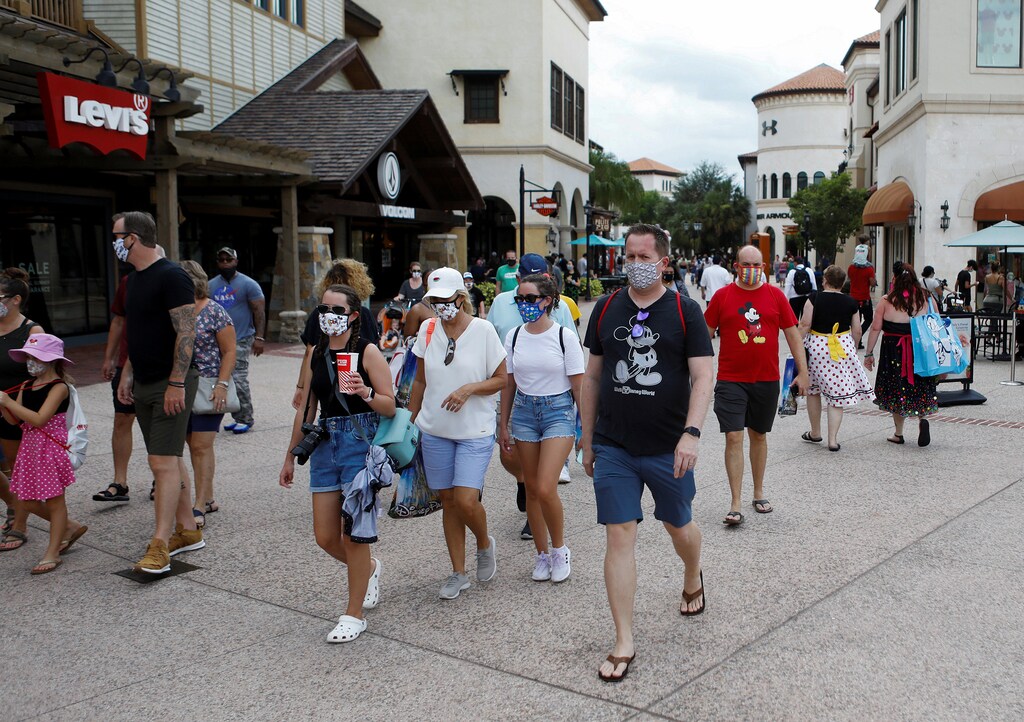 Disney Springs shoppers wear face masks and Disney-themed clothing while Walt Disney World conducts a phased reopening from coronavirus disease (COVID-19) restrictions in Lake Buena Vista, Florida, U.S. July 11, 2020. REUTERS/Octavio Jones - RC28RH91SW04