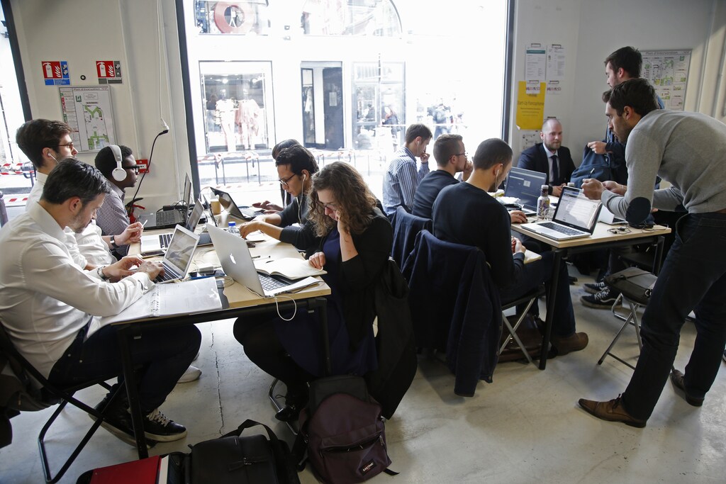 Entrepreneurs work at their computer laptops at the so-called "incubator" of French high-tech start-ups "Numa" in Paris, France, March 11, 2016.