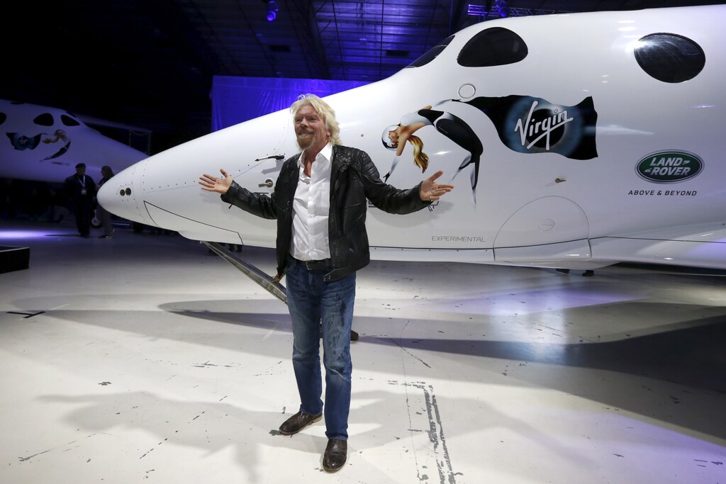Richard Branson poses after unveiling the new SpaceShipTwo, a six-passenger two-pilot vehicle meant to ferry people into space that replaces a rocket destroyed during a test flight in October 2014, in Mojave, California, United States, February 19, 2016. REUTERS/Lucy Nicholson - RTX27RNB