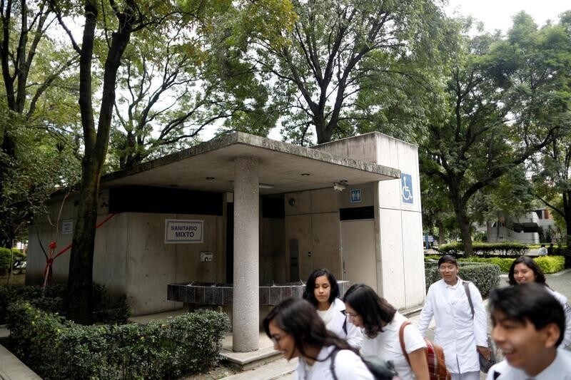 Students walk past a front of an all-gender toilet of the National Autonomous University of Mexico (UNAM) in Mexico City, Mexico October 3, 2018. Picture taken October 3, 2018. REUTERS/Edgard Garrido - RC1B43F36C90