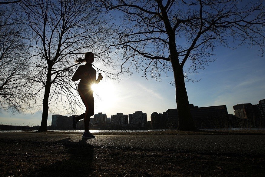 A woman jogs along the Charles River on an early spring evening in Boston, Massachusetts April 3, 2014. REUTERS/Brian Snyder