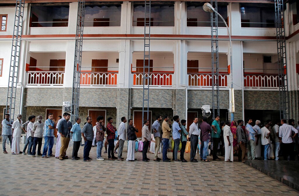 People wait in a queue to cast their votes at a polling station during the third phase of the general election in Kochi, India, April 23, 2019. REUTERS/Sivaram V - RC16E1FAD5C0