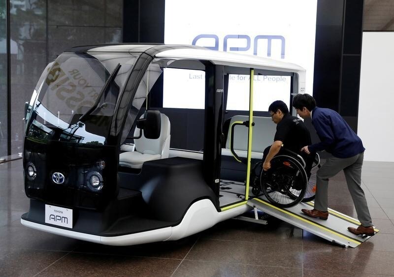 An employee of Toyota Motor Corp. demonstrates APM (Accessible People Mover), a mobility vehicle designed expressly for use at the Tokyo 2020 Olympic and Paralympic Games, during a press preview in Tokyo, Japan July 18, 2019. Picture taken July 18, 2019. REUTERS/Issei Kato - RC1982868A90
