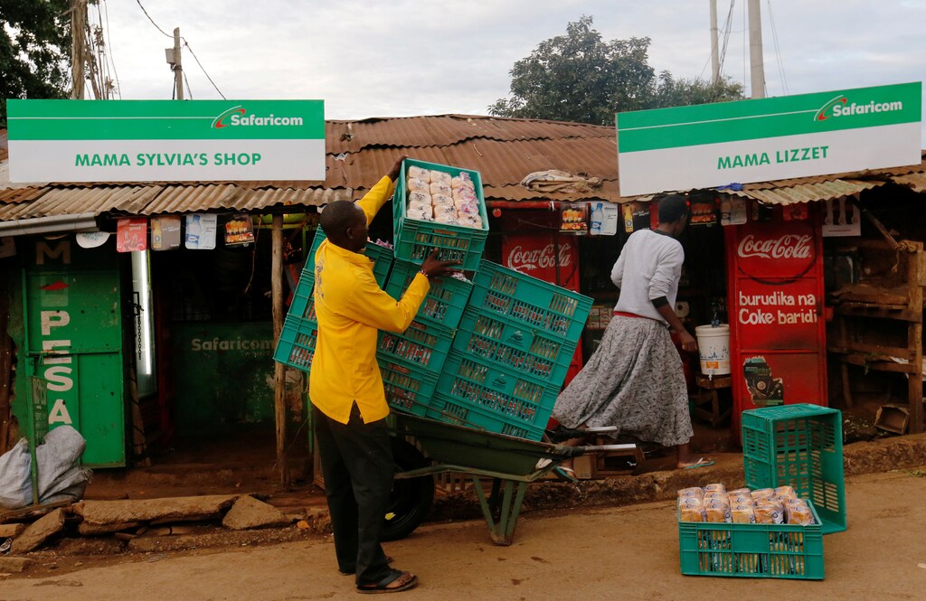 A man arranges crates of bread outside a shop at the end of a night-long curfew ordered by Kenya's President Uhuru Kenyatta to slow the spread of the coronavirus disease (COVID-19), in Nairobi, Kenya March 28, 2020. REUTERS/Thomas Mukoya - RC2USF95CJKV