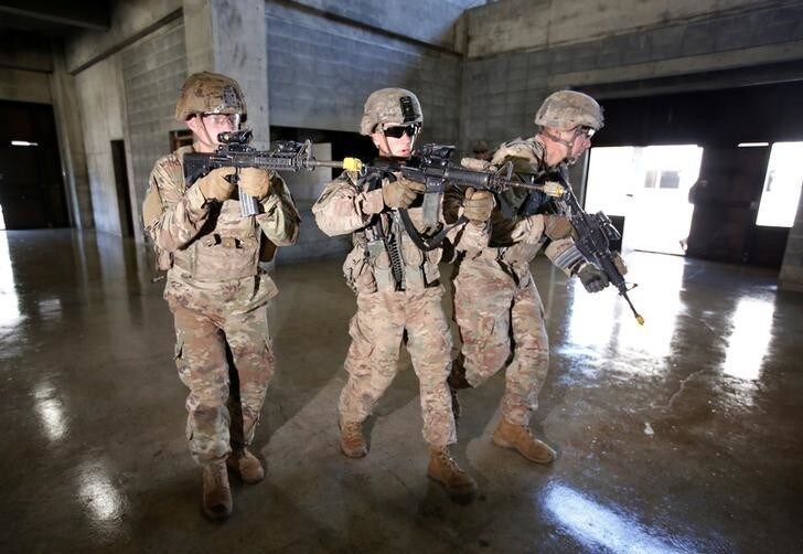 U.S. Army soldiers take part in an urban warfare drill during their joint military exercise, named Orient Shield 17, with Japan Ground Self-Defense Force members near Mount Fuji at Higashifuji training field in Gotemba, west of Tokyo, Japan September 18, 2017. REUTERS/Issei Kato
