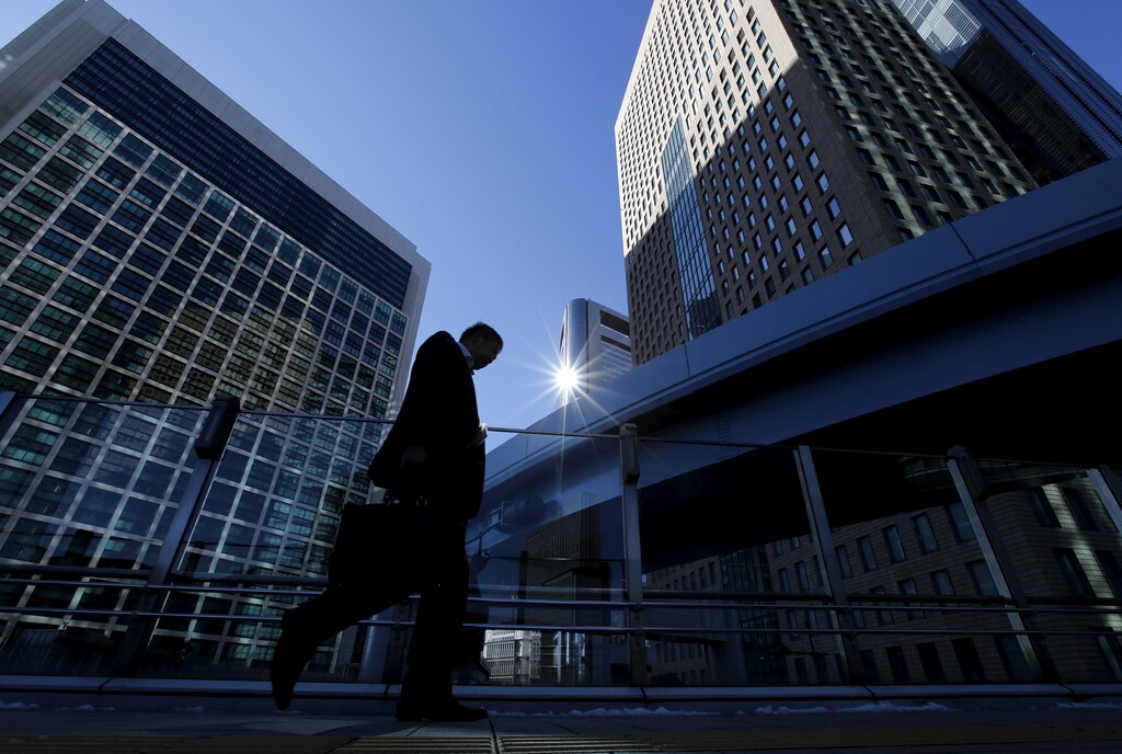 A businessman walks in Tokyo's business district, Japan January 20, 2016.