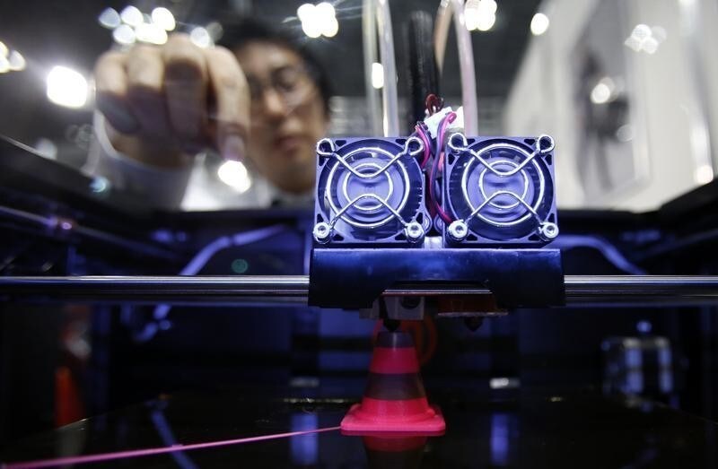 A staff member of Nihonbinary demonstrates their 3D printer MakerBot Replicator 2X as it prints an Acrylonitrile butadiene styrene pylon during the International Robot Exhibition 2013 in Tokyo November 8, 2013. Japanese entrepreneurs are building businesses based on 3D printing, showing the sort of pioneering spirit Prime Minister Shinzo Abe hopes can revitalise a calcified economy. Whether these entrepreneurs can lay the foundations for a new era in Japanese products though may depend on whether Abe can tear down barriers in a wider business culture that shuns risk and supports the status quo. Picture taken November 8, 2013. To match Feature JAPAN-ECONOMY/3DPRINTER REUTERS/Yuya Shino (JAPAN - Tags: BUSINESS) - GM1E9C30EB201