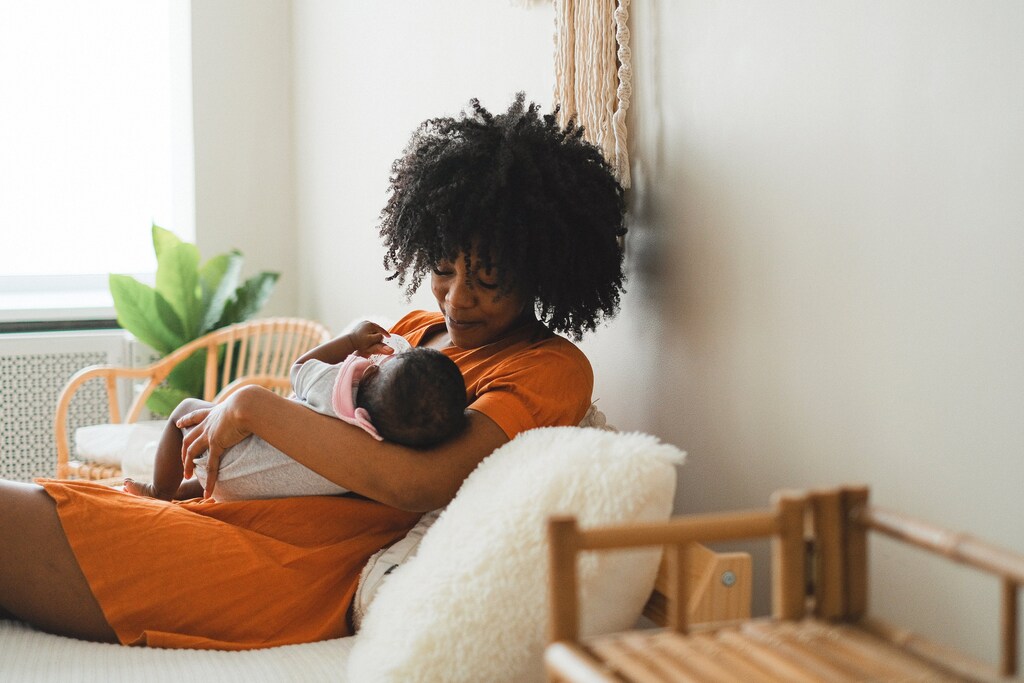 Mother and baby cuddling, enjoying paid family leave.