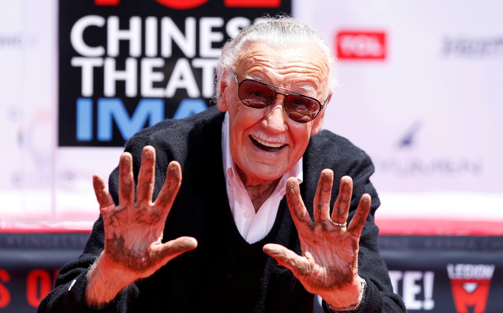 Marvel Comics co-creator Stan Lee shows his hands after placing them in cement during a ceremony in the forecourt of the TCL Chinese theatre in Los Angeles, California, U.S., July 18, 2017. REUTERS/Mario Anzuoni - RC182D2F85A0