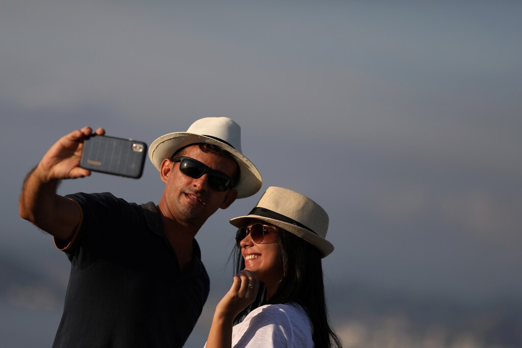 A couple pose for a selfie at a lookout point in Rio de Janeiro, Brazil, May 10, 2019. REUTERS/Pilar Olivares - RC19B7841B60