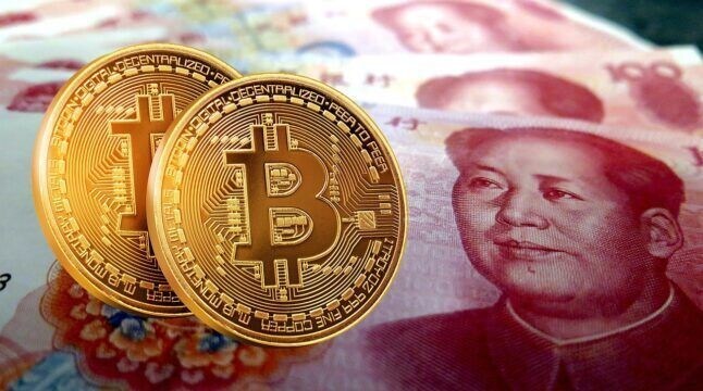 A photo of Bitcoin and a 100 renminbi note.