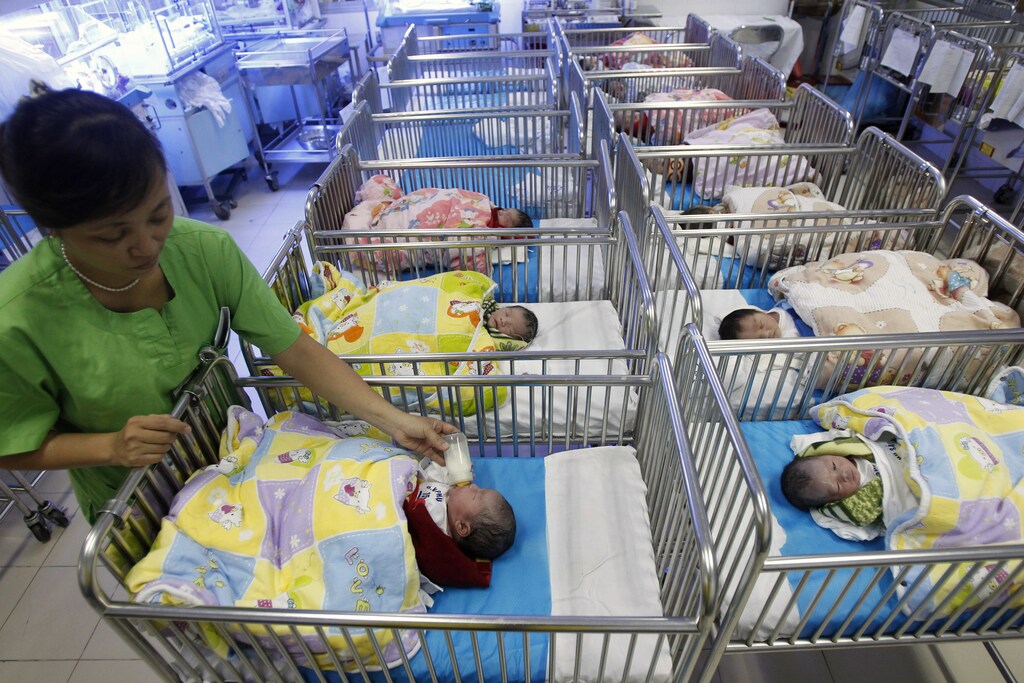 A nurse feeds a newborn baby at the Central Obstetrics Hospital in Hanoi October 27, 2011.