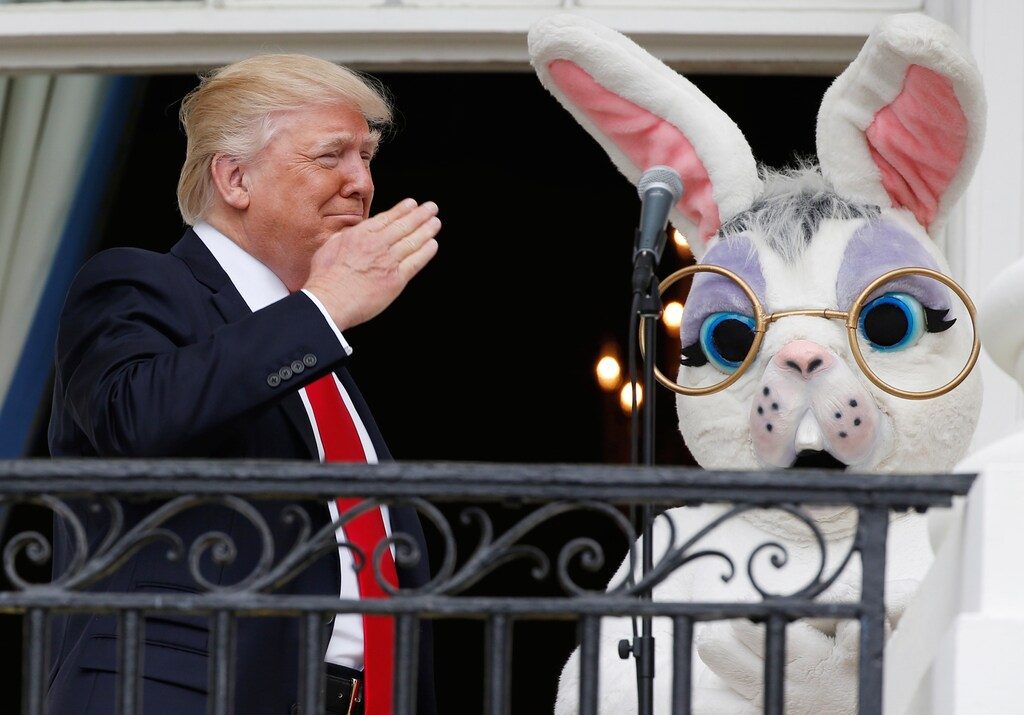 U.S. President Donald Trump salutes a member of the military (not seen in photo) who had just sung the U.S. national anthem as he stands with a performer in an Easter Bunny costume at the White House Easter Egg Roll on the Truman Balcony of the White House in Washington, U.S., April 17, 2017. REUTERS/Joshua Roberts TPX IMAGES OF THE DAY - RTS12N8U