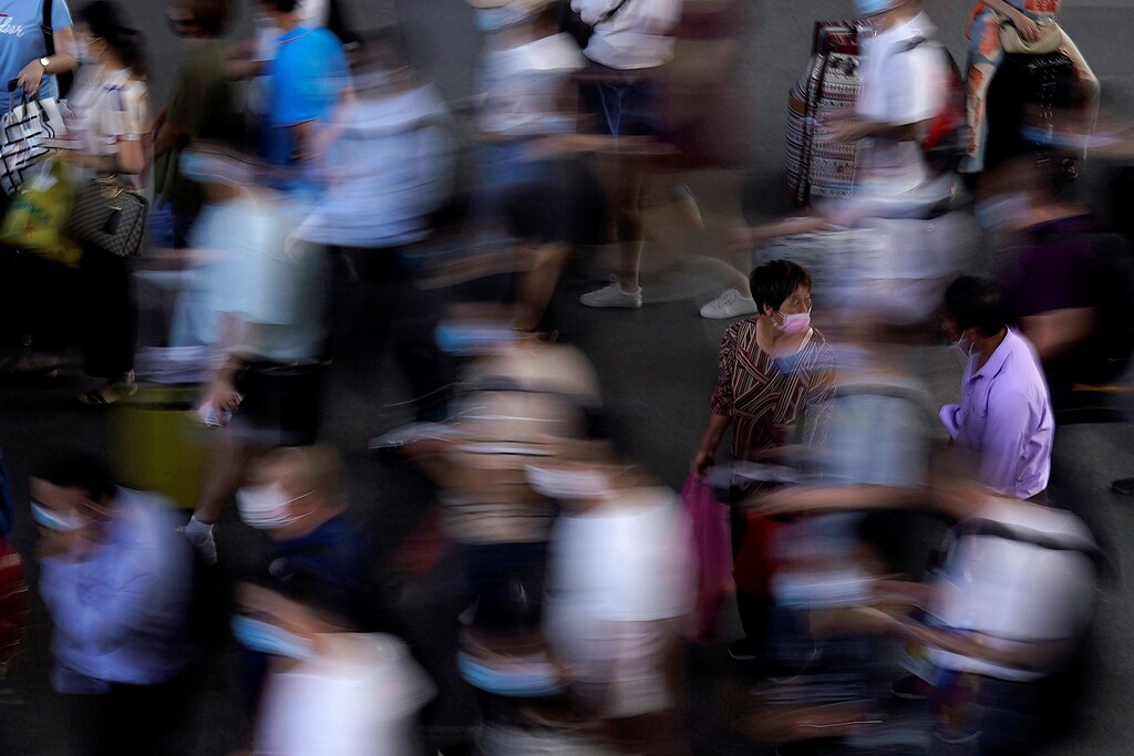 People wearing face masks wait for the train at Suzhou Railway Station, following the coronavirus disease (COVID-19) outbreak, in Suzhou, Jiangsu province, China July 7, 2020. Picture taken July 7, 2020. REUTERS/Aly Song TPX IMAGES OF THE DAY - RC2POH9RBKOH