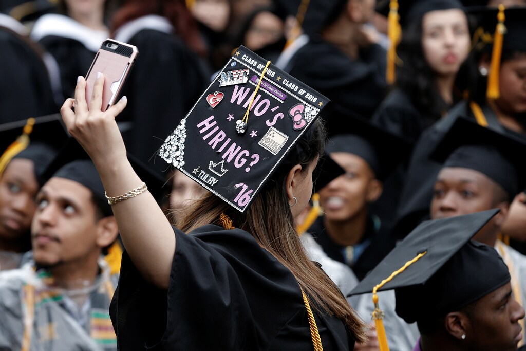 A graduating student of the City College of New York takes a selfie of the message on her cap during the College's commencement ceremony in the Harlem section of Manhattan, New York, U.S., June 3, 2016