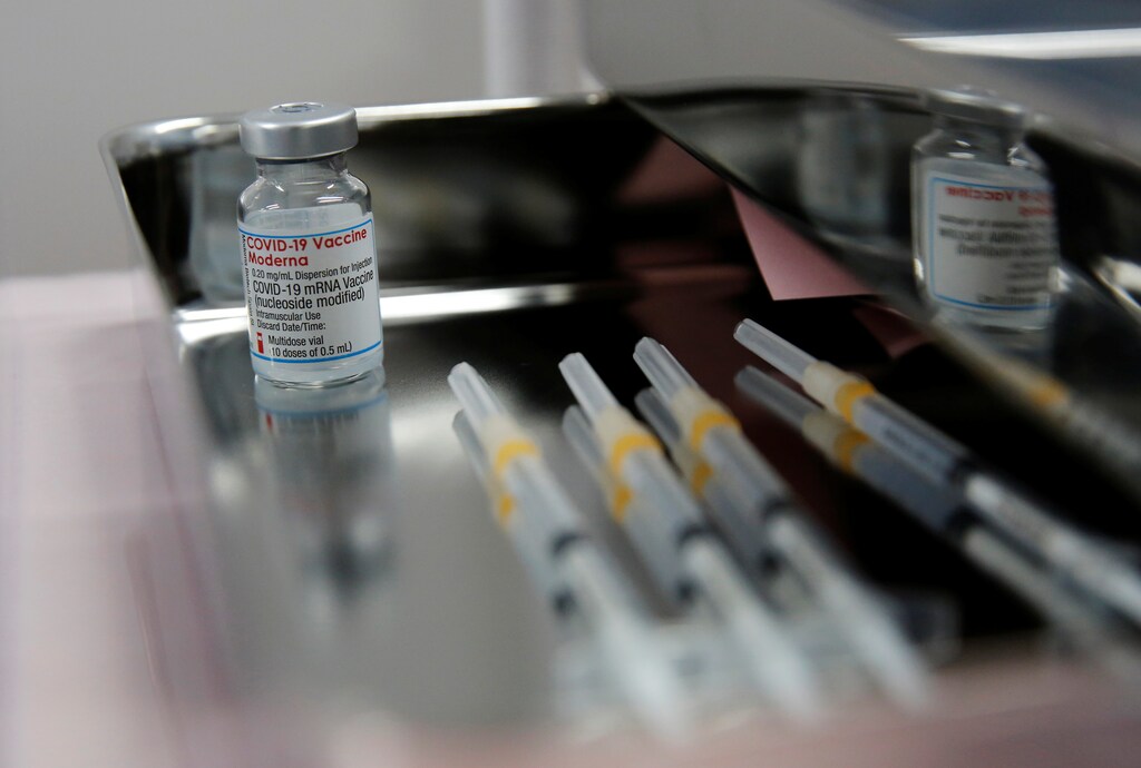 A vial containing doses of the Moderna vaccine against the coronavirus disease (COVID-19) and syringes are pictured at Japan Airlines (JAL) facility where its staff receive the vaccines at Haneda airport in Tokyo, Japan June 14, 2021. REUTERS/Kim Kyung-Hoon - RC240O9RO1KK