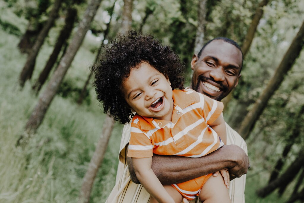 A father and son smiling.