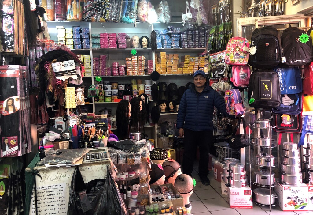 Ram Thapa waits for customers in his shop in Alexandra township in Johannesburg, South Africa, July 19, 2019. Picture taken July 19, 2019. REUTERS/Emma Rumney - RC1ED3321E00
