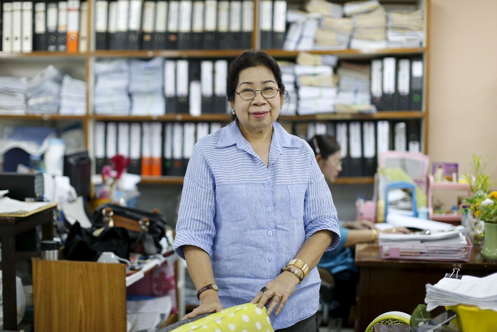 Sunisa Hongaroon, a 67-year-old accountant, poses for a portrait while working at a transportation company in Bangkok, Thailand.