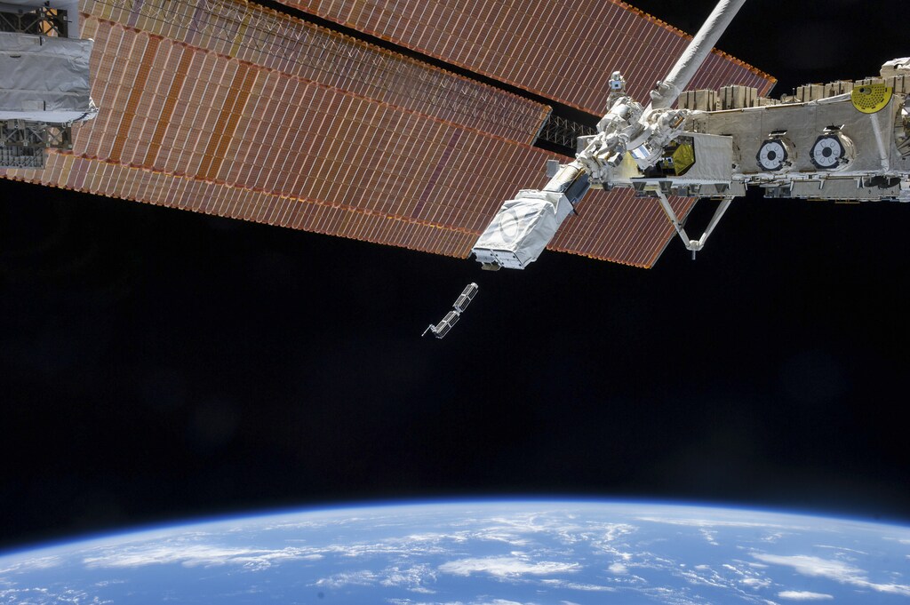 The Small Satellite Orbital Deployer (SSOD), in the grasp of the Kibo laboratory robotic arm, is photographed by an Expedition 38 crew member on the International Space Station as it deploys a set of NanoRacks CubeSats in this February 11, 2014 NASA photo. The CubeSats program contains a variety of experiments such as Earth observations and advanced electronics testing. Station solar array panels, Earth's horizon and the blackness of space provide the backdrop for the scene. REUTERS/NASA/Handout (UNITED STATES - Tags: SCIENCE TECHNOLOGY) FOR EDITORIAL USE ONLY. NOT FOR SALE FOR MARKETING OR ADVERTISING CAMPAIGNS. THIS IMAGE HAS BEEN SUPPLIED BY A THIRD PARTY. IT IS DISTRIBUTED, EXACTLY AS RECEIVED BY REUTERS, AS A SERVICE TO CLIENTS - RTX18OV7