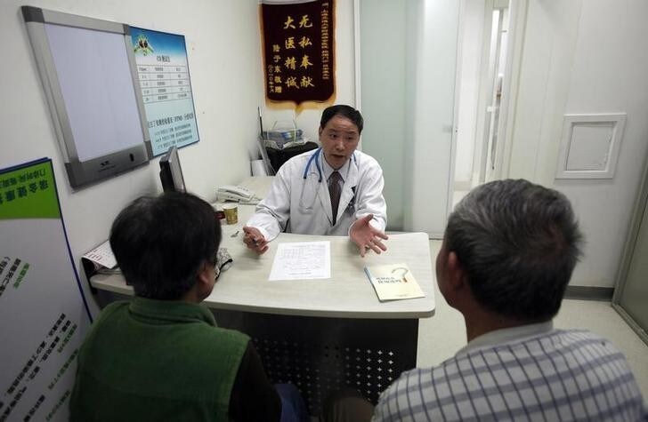 Doctor Lu Ankang talks with patients with respiratory problems caused by smoking at Ruijin Hospital in Shanghai April 27, 2011. China will ban smoking at all indoor public venues from May 1, in an effort to shield the world's most populous nation, and its largest cigarette producer, from the harmful effects of the habit, the health ministry said. China, which has more than 300 million smokers, will require businesses to display prominent no-smoking signs, forbid vending machines from selling cigarettes and ensure that designated outdoor smoking zones not affect pedestrian traffic. Although nearly 1.2 million Chinese people die from smoking-related diseases each year, the habit is deeply entrenched in public li