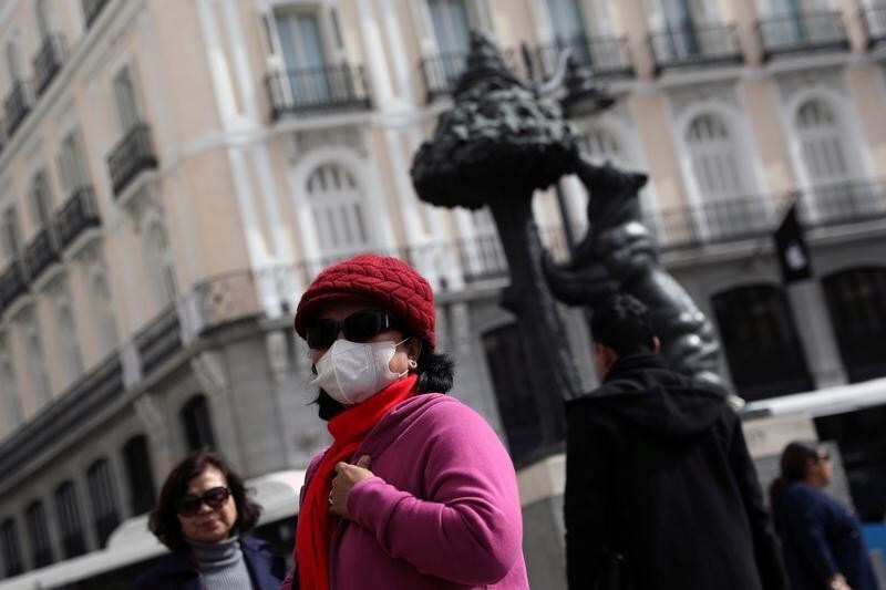 A tourist wears a protective mask outside Puerta del Sol square amid the novel coronavirus outbreak in Madrid, Spain, February 27, 2020. REUTERS/Susana Vera - RC239F96VVFP