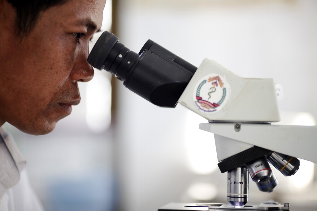 A health worker checks a blood sample for malaria in the only hospital in Pailin in western Cambodia January 28, 2010. Bordering with Thailand, this former Khmer Rouge stronghold and dusty gem mining town is now better known for a malarial parasite that is worrying health experts in the region. Studies and research show artemisinin-based therapies - currently the most effective treatment against malaria - are taking longer to cure some of the patients. REUTERS/Damir Sagolj (CAMBODIA - Tags: HEALTH POLITICS SOCIETY) - RTR29KVT