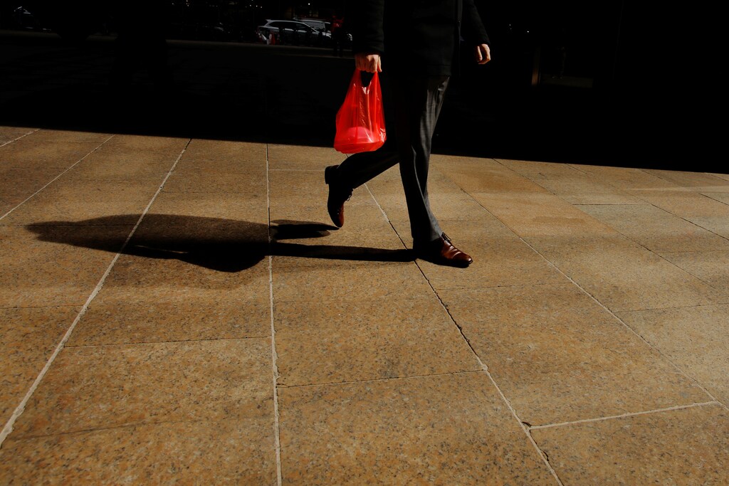 A pedestrian carries a plastic bag while walking down the street in New York, U.S., April 2, 2019. REUTERS/Lucas Jackson