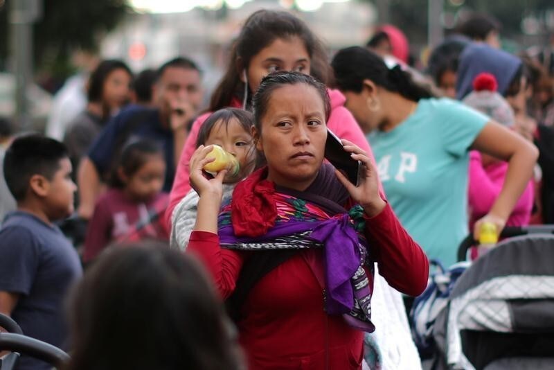 People wait in line at the Fred Jordan Mission annual back-to-school giveaway of shoes, clothing and backpacks for 3,000 homeless and underprivileged children in Los Angeles, California, United States, October 4, 2018.