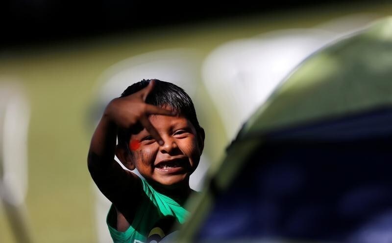 A child from a local indigenous community plays at the Terra Livre camp, or Free Land camp, during a demonstration in defence of local indigenous people, in Brasilia, Brazil April 23, 2018.