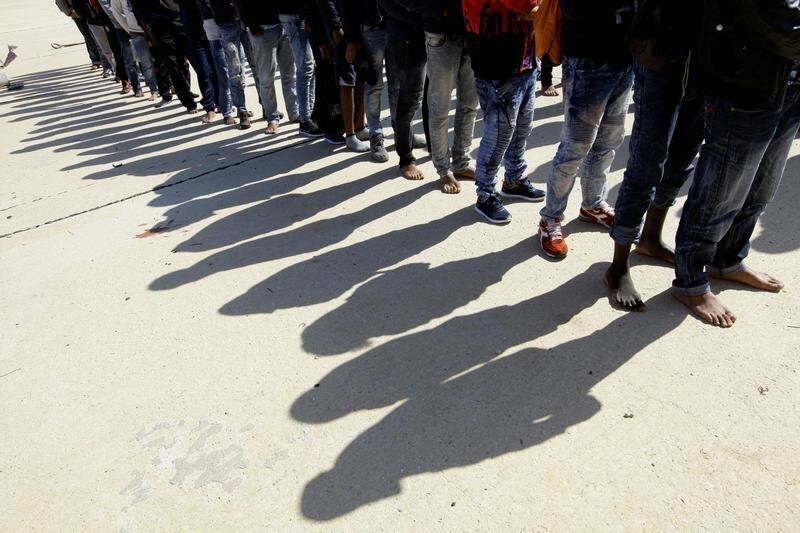Migrants stand at a naval base after they were rescued by Libyan coastguard, in Tripoli, Libya October 18, 2017. REUTERS/Ismail Zitouny - RC19A1E36C90