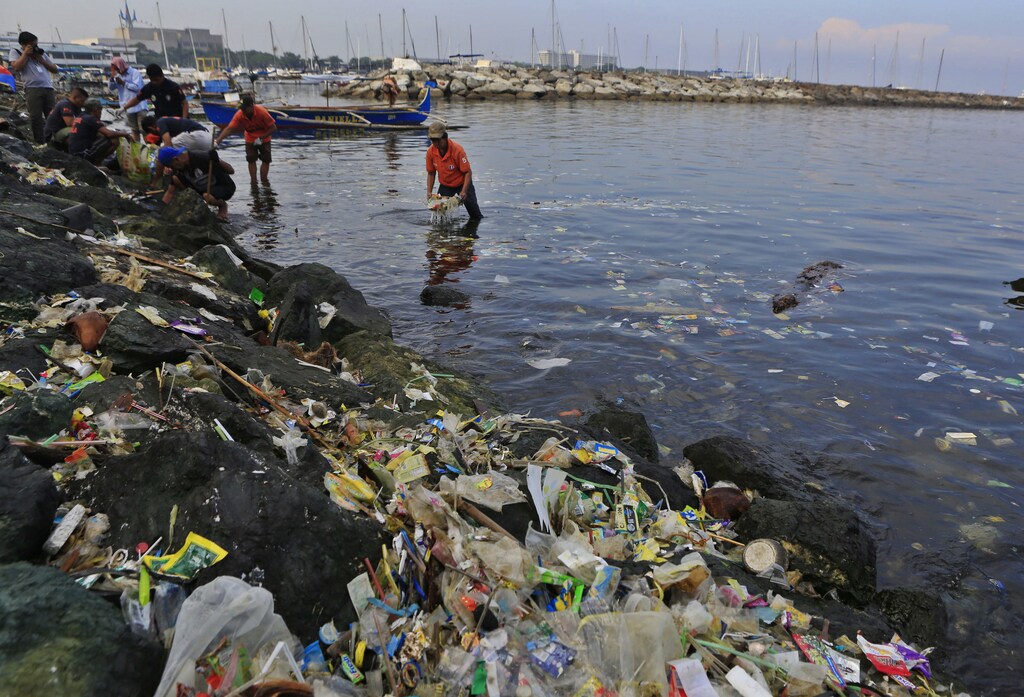 Government sanitary workers collect and segregate plastic pollution in Manila bay July 3, 2014.