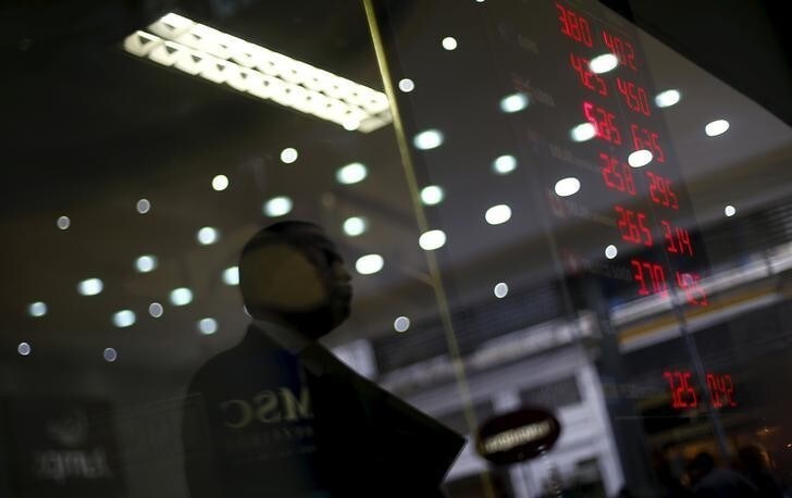 A man is reflected on the glass as he observes a board showing the Real-U.S. dollar and several foreign currencies exchange rates in Rio de Janeiro, Brazil, September 10, 2015. One thing is clear for Brazil's economy after its credit rating was downgraded to junk: political leaders now have little choice but to push ahead with painful austerity measures if they hope to regain market confidence. Standard & Poor's on Wednesday stripped Brazil of its hard-won investment grade rating, moving sooner than the government and investors had expected. Although investors expected a downgrade at some point, they still sold off Brazilian assets early on Thursday. Stocks suffered modest losses while the currency, the real, fell nearly 3 percent to a 13-year low of 3.9 per dollar. REUTERS/Ricardo Moraes