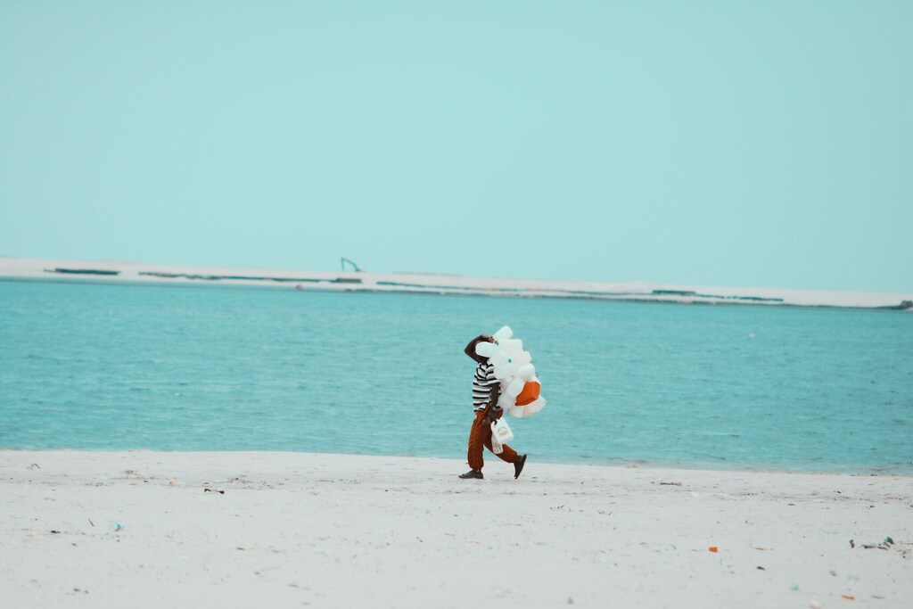 Boy walks along the beac with plastic bottles: Inclusive and impactful policy measures are needed to address plastic pollution in Africa.