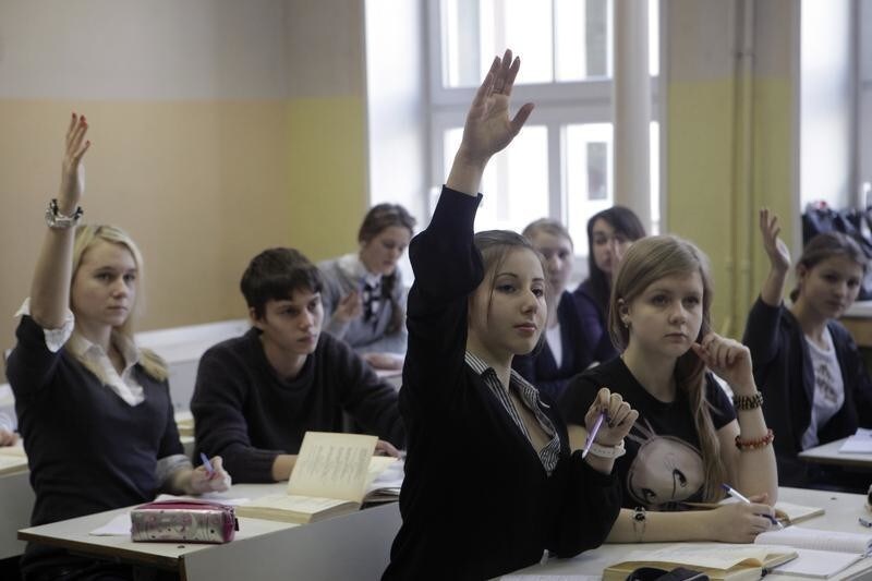 Russian-speaking students raise their hands as they attend a Russian literature lesson in school in Riga February 15, 2012.