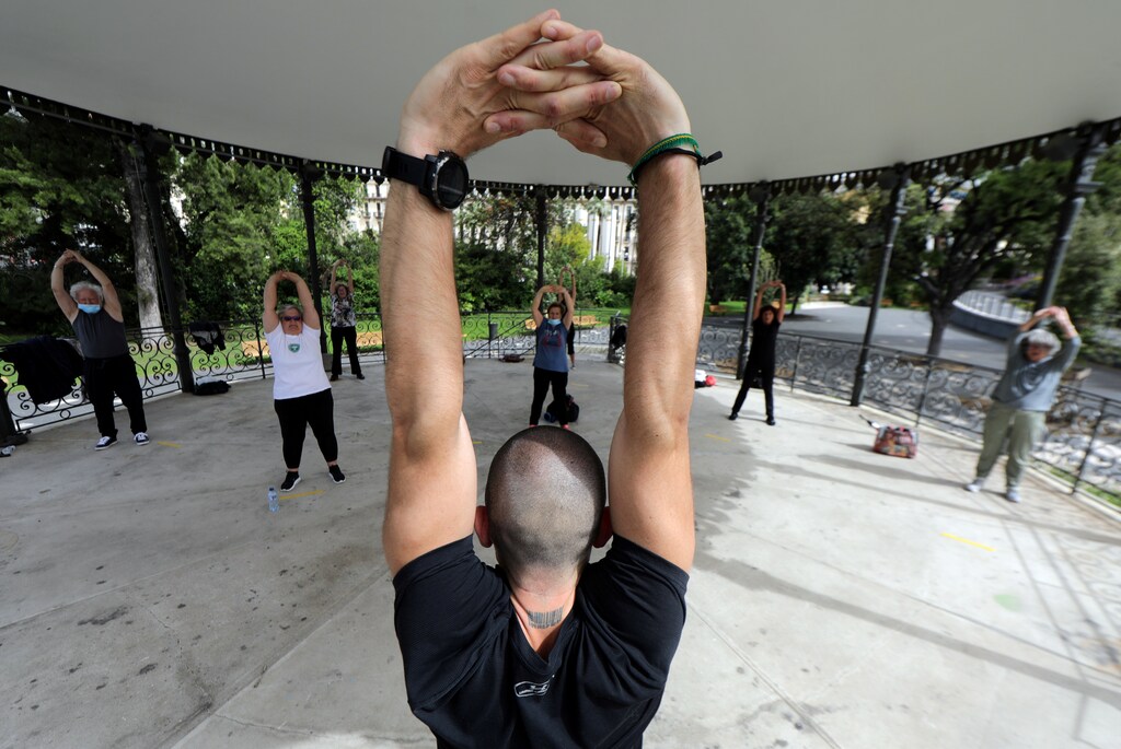 A group of elderly people practice exercise with social distancing in the bandstand of Albert 1er public garden in Nice as France softens its strict lockdown rules during the outbreak of the coronavirus disease (COVID-19) in France, May 13, 2020. REUTERS/Eric Gaillard - RC2MNG985R7O