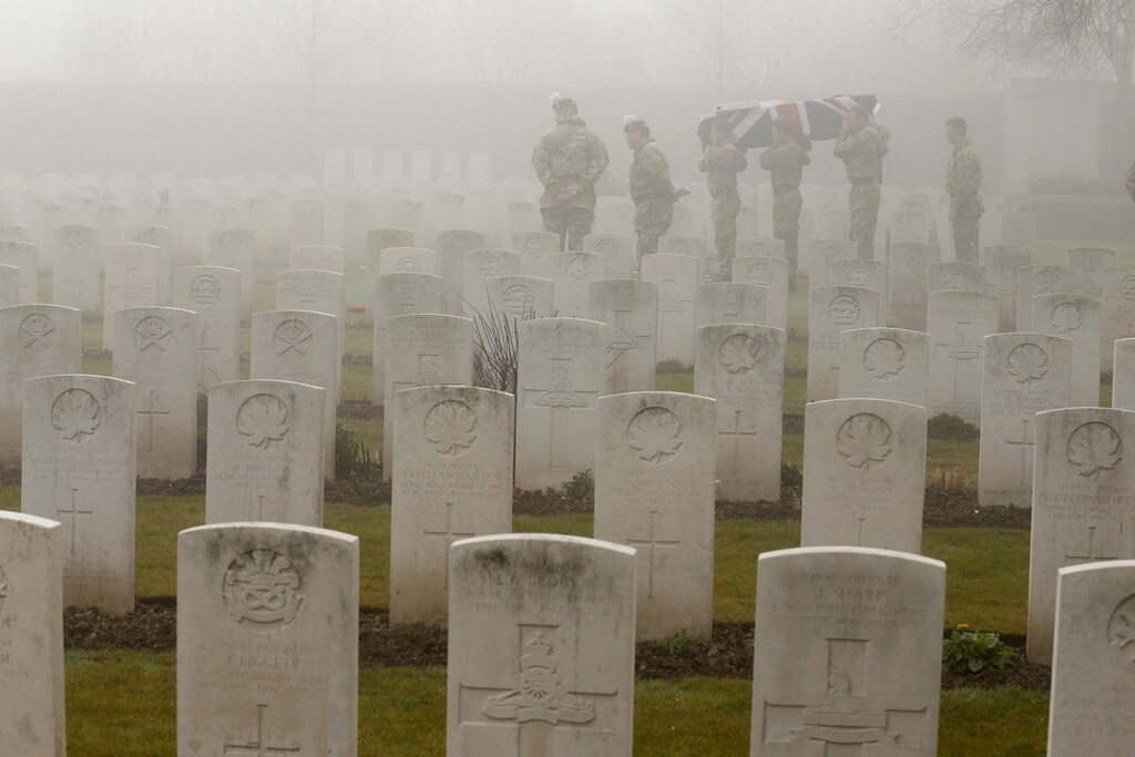 Soldiers of the 2nd Battalion of the Royal Regiment of Scotland carry an empty coffin at a WWI memorial during a rehearsal for a reburial ceremony at the Loos-en-Gohelle Commonwealth war cemetery near Lens in northern France, March 13, 2014. Tomorrow, almost 100 years after they were killed in action in the battle of Loos in 1915, twenty British soldiers will be reinterred here. REUTERS/Pascal Rossignol (FRANCE - Tags: ANNIVERSARY MILITARY CONFLICT TPX IMAGES OF THE DAY) - RTR3GYMZ