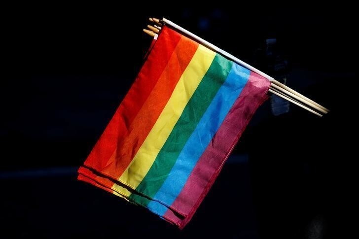 A man sells rainbow flags near The Stonewall Inn, on the eve of the LGBT Pride March, in the Greenwich Village section of New York City, , U.S. June 24, 2017. REUTERS/Brendan McDermid